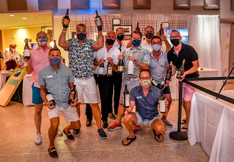 Helpers hold the group of fine wines sold during Saturday night’s live auction. Shown are in back (l-r) Keith Petrack, CAMP Rehoboth VP Wes Combs, Joe Vescio, Barry Moshinski, Michael Fetchko, Jeff Davidson, Eric Gannon, and Eric Engelhart. In front are CAMP Rehoboth Secretary Mike DeFlavia and President Chris Beagle.