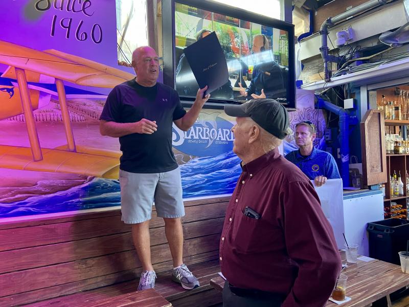 Speaker of the House Rep. Pete Schwartzkopf, D-Rehoboth, presents Dewey Beach Mayor Dale Cooke with a tribute from the House of Representatives.