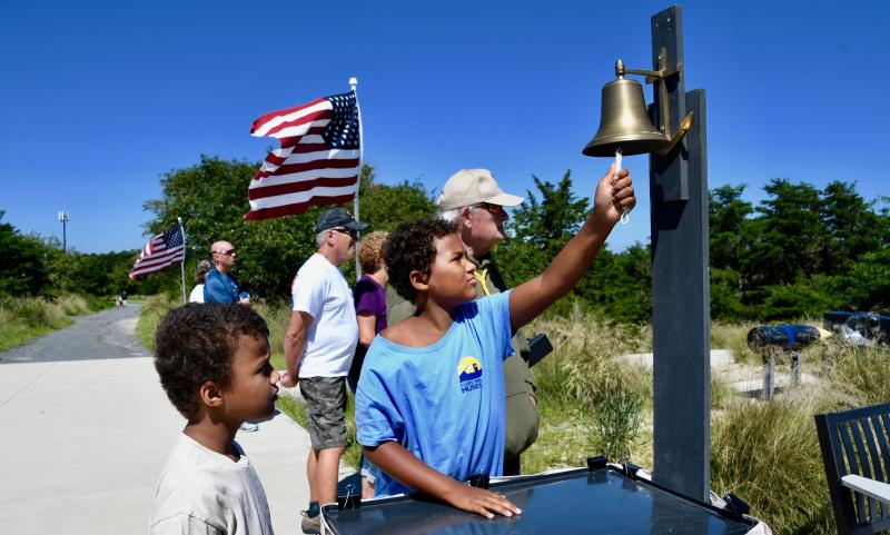Max and Zak Wray, grandsons of former FMHA President Gary Wray, ring a ship’s bell after each name of Delaware’s fallen heroes is read.