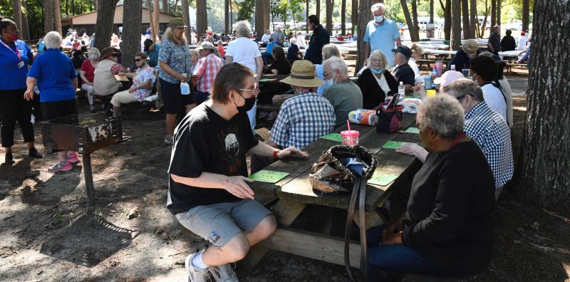 Picnic tables at Trap Pond State Park are full with people playing bingo. Nearly everyone was a winner.