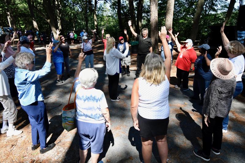 DJ Sky Brady gets everyone circled up to do some exercises before playing games.