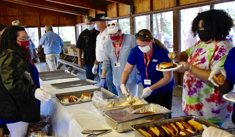 Sussex County CHEER staff and volunteers are busy putting picnic food, including hot dogs, cheeseburgers and baked beans, on plates during a county-wide picnic and festival held Sept. 3 at Trap Pond State Park near Laurel. RON MACARTHUR PHOTOS