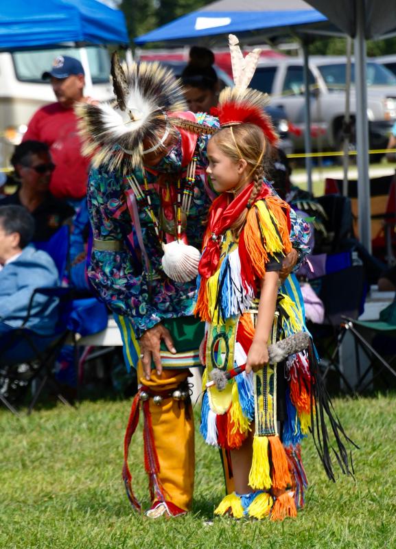 Luke Wright, an 8-year-old Nanticoke Tribe member, gets some last-minute advice from this uncle, Mike Harmon, as he begins his first powwow dance session.