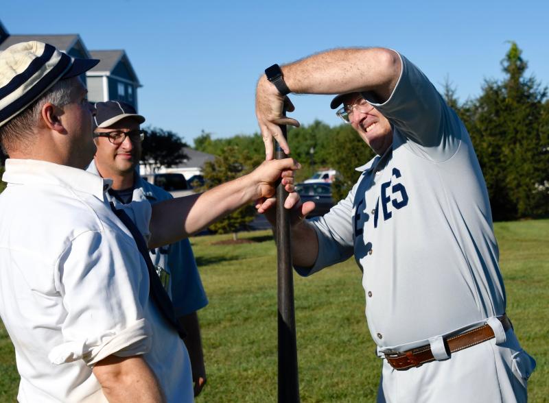 To start each game, teams try to top off a bat for home field advantage. Russell “Five Points” Huxtable, right, covers the top of the bat, giving Brandywine’s Brian “Powder” Carroll no chance, as Mike “Oyster” DiPaolo looks on.