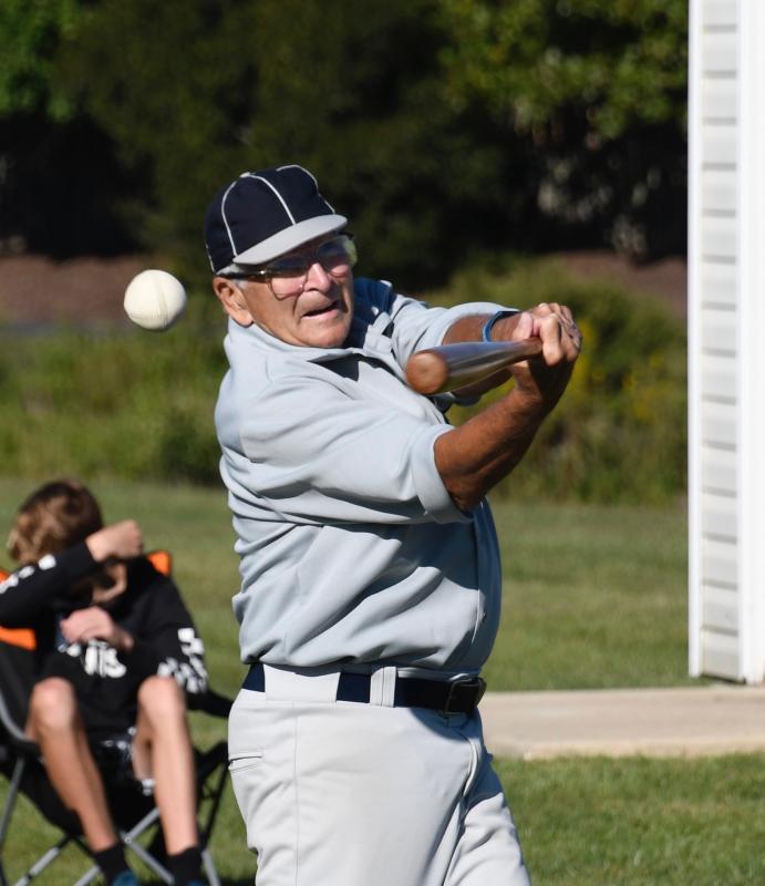 The ball goes off the bat of Warren “Yankee” Miller, who plays third base for the Lewes Base Ball Club. Miller, who is 80 years old, played professional baseball in the Yankees’ minor leagues.