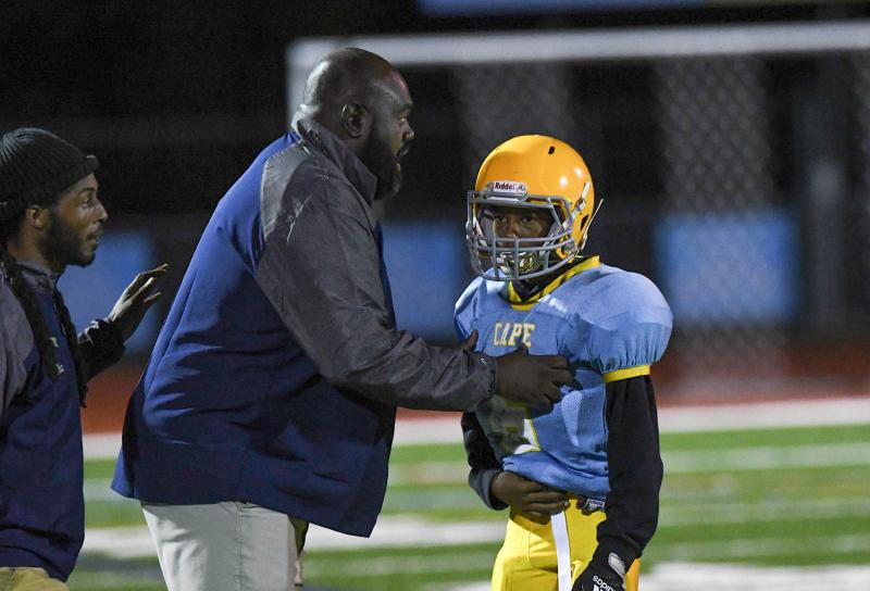 Mariner head coach Billy Collick speaks to his quarterback Camryn Joyner while assistant coach Tykee Joyner listens.