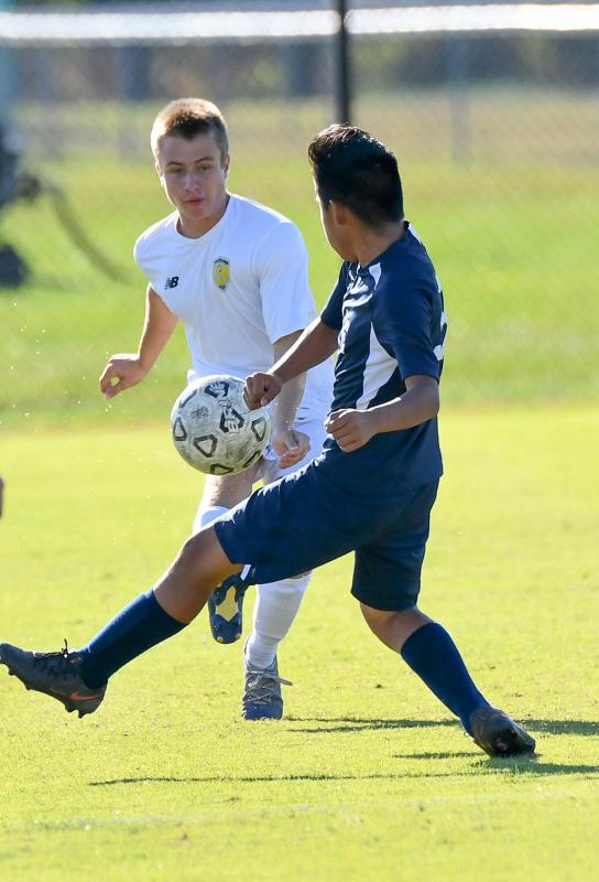 Cape junior Mason Mendes boots the ball past Lake’s Ricardo Garcia.