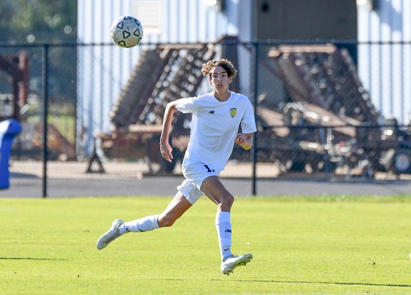 Senior Nick Schweitzer runs down a high ball in the offensive half.