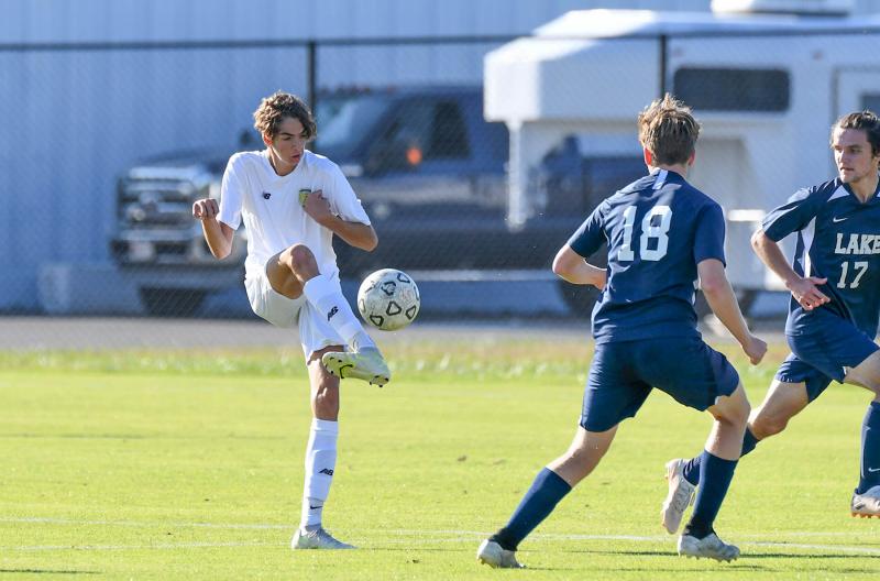 Senior Nick Schweitzer passes over the Lake Forest front line.