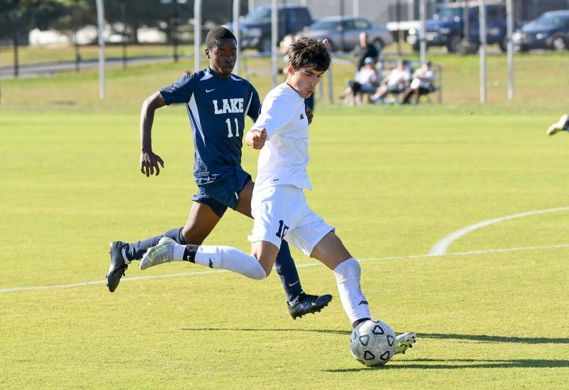 Cape’s Aldo Hernandez-Becerra passes the ball up field away from Lake’s Coen Dempsey.