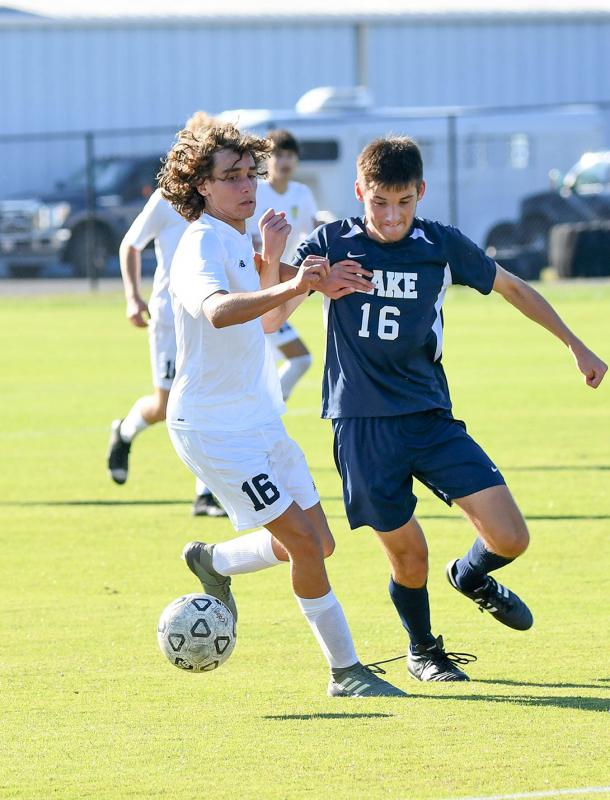 Cape’s Alex Shives, left, and Lake’s Cole Miller battles for a 50/50 ball.