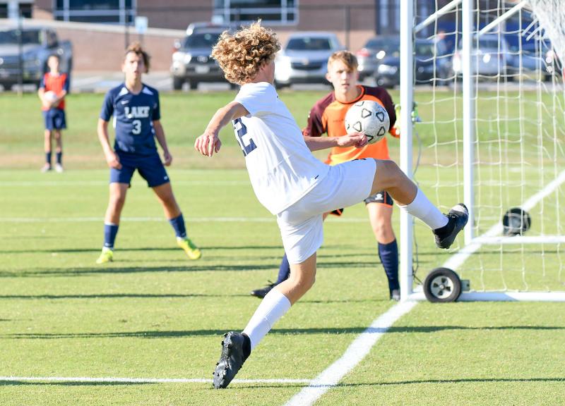 Freshman Evan Burris pops a shot on Lake goalie Jackson Massey.