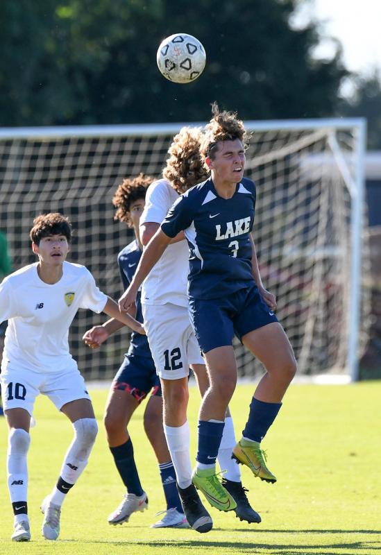 Lake’s Jackson Starkey heads the ball away from the Cape offense.
