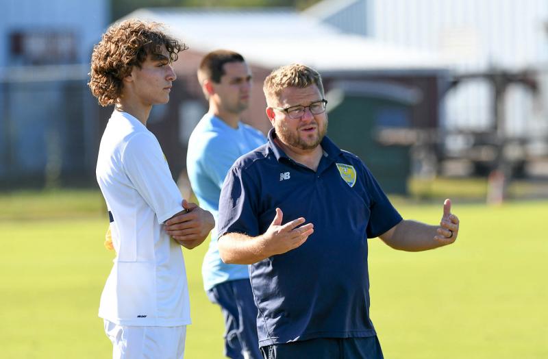 Cape coach Patrick Kilby, right, explains a play to Daniel Shives.