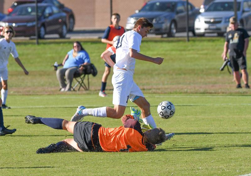 Cape’s Niko Panyko avoids a save attempt by Lake goalie Jackson Massey and scores for the Vikings.