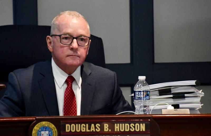 Sussex County Council District 4 Councilman Doug Hudson listens to testimony while keeping the nearly 1,000 pages on the application in the public record close at hand.