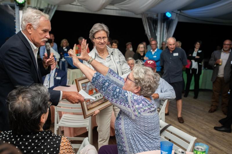 DDA Secretary Michael Scuse (left) served as auctioneer during the very lively Gallery One art auction.