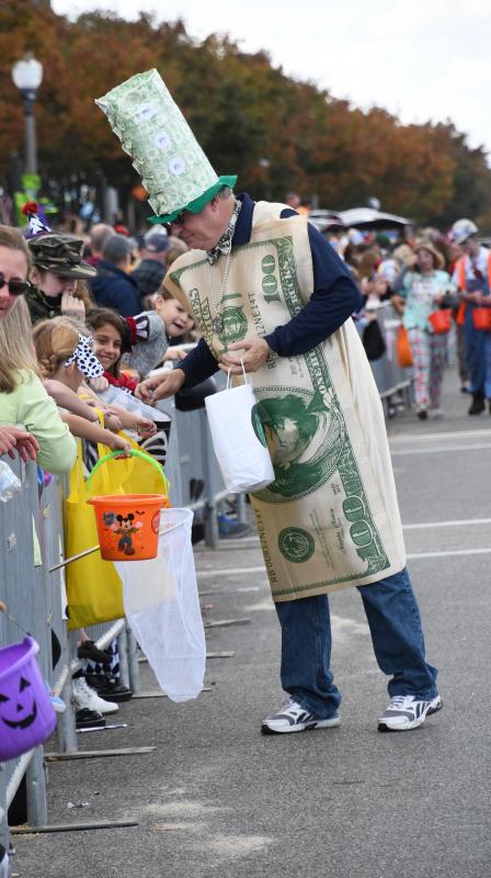 Community Bank Delaware President Jack Riddle digs into his bag of treats. Rumor has it, he was also handing out $1 bills.