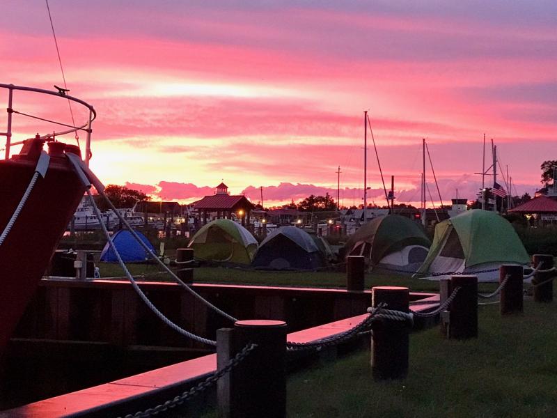A colorful Oct. 9 sunrise over Canalfront Park in Lewes greets campers who slept out in tents for the Night Without a Bed event. ELAINE SIMMERMAN PHOTO