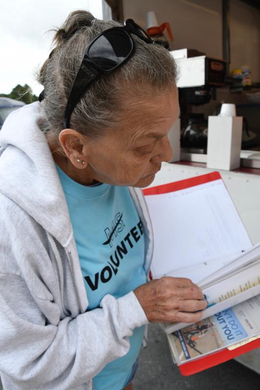 Rebekahs volunteer Ruth Scott looks over a thick scrapbook she keeps to commemorate the club’s involvement in the annual cycling event.