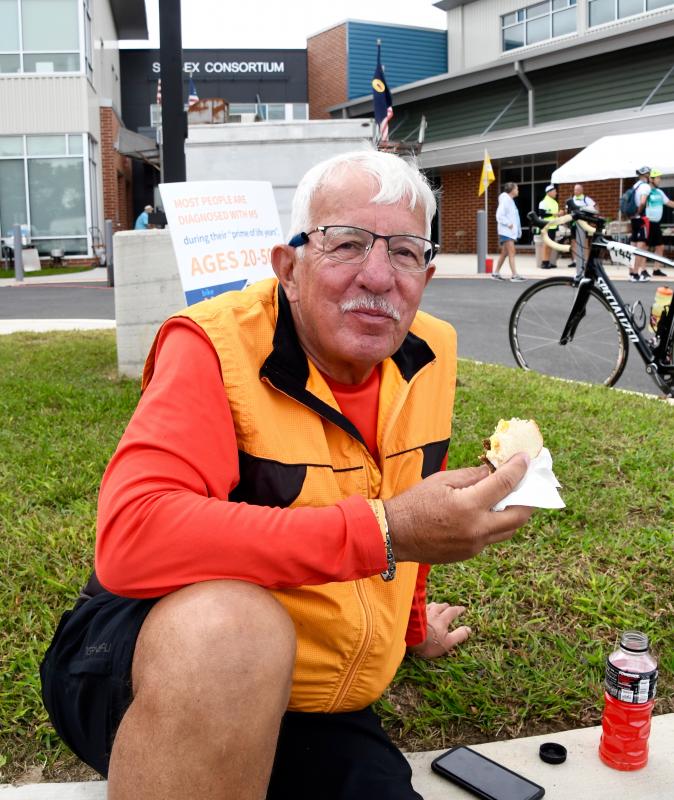 Stephen Wasylyszyn, riding in his 17th Bike to the Bay, pauses to enjoy a scrapple and egg sandwich prepared by the Odd Fellows at the Sussex Consortium rest stop.