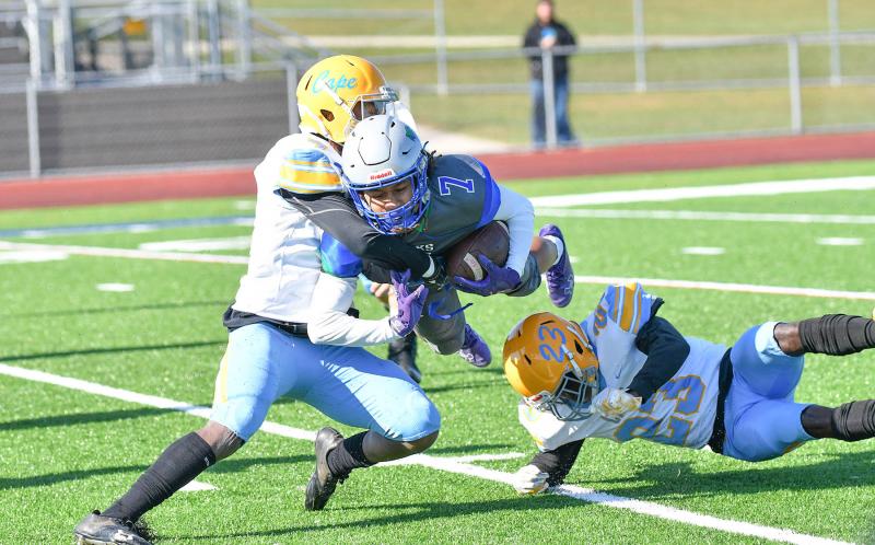 Chancler Johnson, right, is injured assisting Maurki James in making a tackle on St. Georges player Gi'Vonni Sanchez.