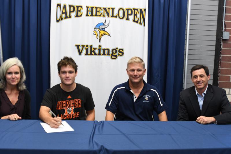 Mikey Frederick with parents Liza and Dave Frederick, and lacrosse coach Mark D’Ambrogi. Mikey will be attending Mercer University to play lacrosse for the Division I Bears of the Southern Conference. Chad Surman is the head coach.