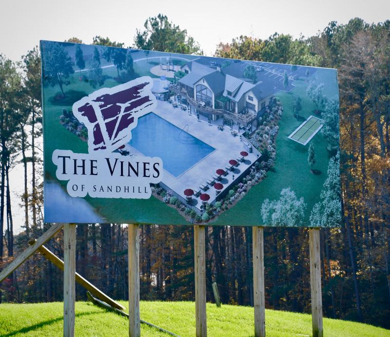 A large billboard depicts the two-story clubhouse approved as part of the original Vines of Sandhill amenities plan.