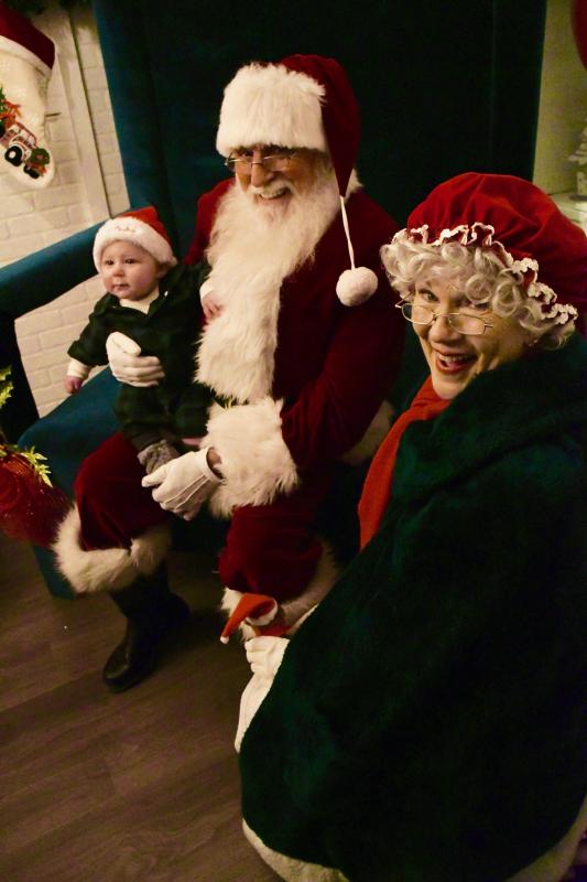 Four-month-old George Arnold is happy to visit with Santa and Mrs. Claus at Santa’s house in Schellville.