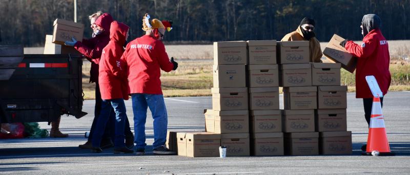 Volunteers load food boxes Nov. 23 at the Crossroad Community Church distribution center near Georgetown.