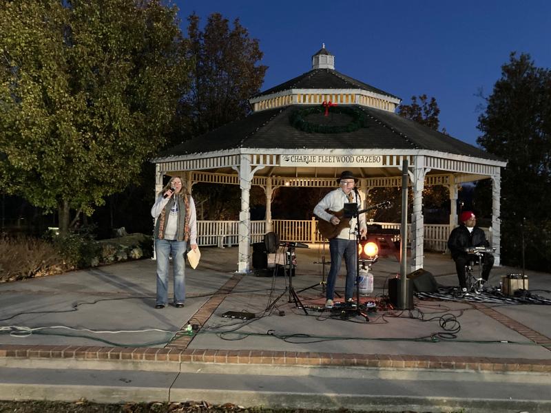 Entertainment at the event was provided by the duo of Al Frantic on guitar and Cooper Fenton on drums. The group, shown with MC Mary Knight, played a mix of Christmas songs and rock oldies at the Charlie Fleetwood Gazebo.