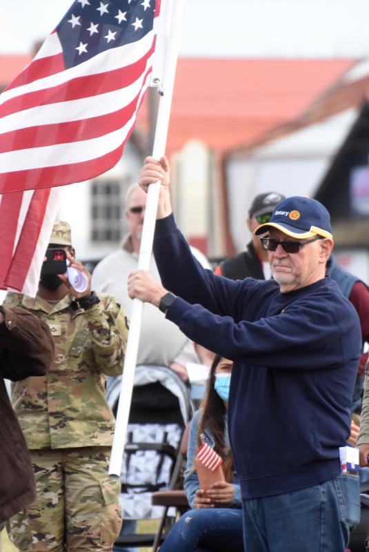 Lewes-Rehoboth Rotary Club President Bill Huntley displays the flag dedicated to the 946th Transportation Company as part of the club’s Flags for Heroes display at Cape Henlopen High School. NICK ROTH PHOTO