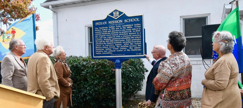 Reading the new Delaware Public Archives historic sign are (l-r) Rep. Richard Collins, R-Millsboro; Sen. Gerald Hocker, R-Ocean View; Rep. Ruth Briggs King, R-Georgetown; Stephen Marz, state archivist; Bonnie Hall, commemoration chair; and Natosha Norwood Carmine, Nanticoke Tribe chief.