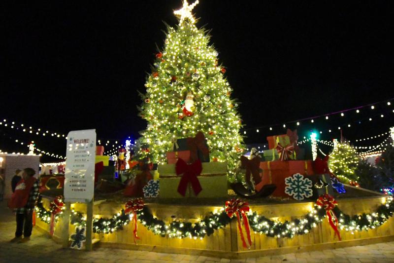 A large Christmas tree welcomes visitors near the entrance to Schellville behind Tanger Outlets Seaside.