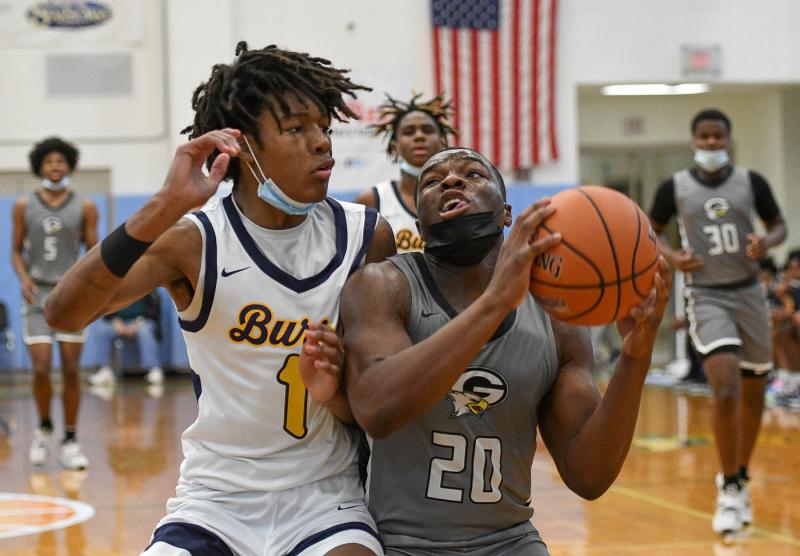 Gray’s Tory Kelly, right, looks to go up strong on West Catholic’s Kaseem Watson.