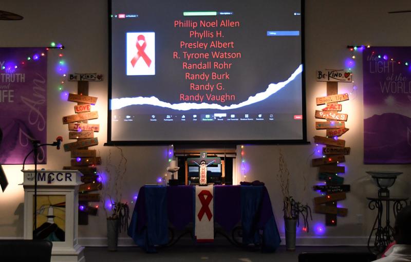 The names of people who died of AIDS in Delaware are scrolled on the big screen during the World AIDS Day Service of Remembrance and Hope.