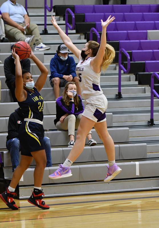 Royals forward Sierra Troyer, right, gets major air to alter the shot of Holly Grove’s Natalie Parks.