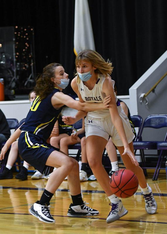 Royals junior Ainsley Bell drives baseline and is fouled by Eagles senior Kirstyn Hubbs.