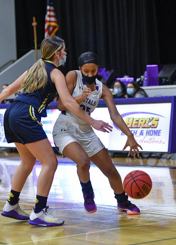 Royals guard Mia Elliott drives past Holly Grove’s Cassidie Bramble.