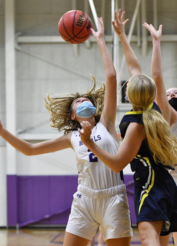 Royals guard Ainsley Bell, left, fights for a rebound.