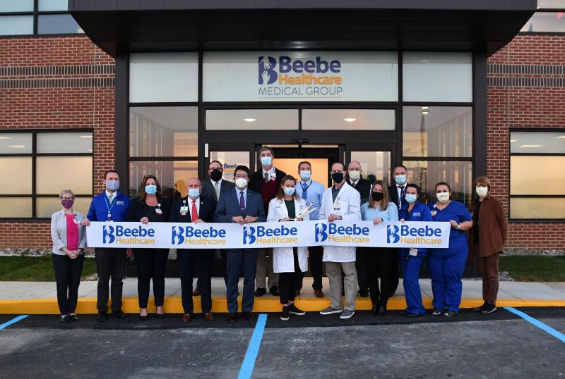 Ribbon-cutting attendees for the new Beebe Primary Care Cape Henlopen offices are (l-r) Christina Deidesheimer, Beebe Healthcare vice president of communications and outreach, chief communications officer; Steven Clayton, Beebe Medical Group director of operations; Danielle Socrates, BMG director of performance operations; Tom Protack, Beebe Medical Foundation president; Stephen Keiser, BMG vice president of operations; Dr. David Tam, Beebe Healthcare president and CEO; Dr. Eric Hale, BMG physician/primary care director; Dr. Bill Chasanov, Beebe Healthcare vice president and chief population health officer; Dr. Lisa Bartels, physician; Aaron Block, PA-C; Rick Schaffner, Beebe Healthcare executive vice president and COO; Christina Onolaja, BMG primary care director of operations; Mike Maksymow, Beebe Healthcare chief information officer; Bridget Doel, LPN; Carissa Toomey, Beebe Healthcare patient services representative; and Betsy Reamer, Lewes Chamber of Commerce executive director. DAN COOK PHOTOS