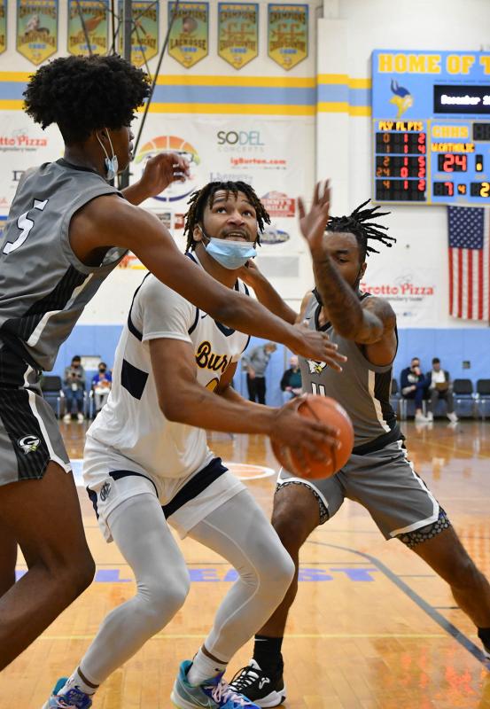 West Catholic’s Marcus Branker is covered by Gray’s Avantae Parker, left, and Calvin Hall.