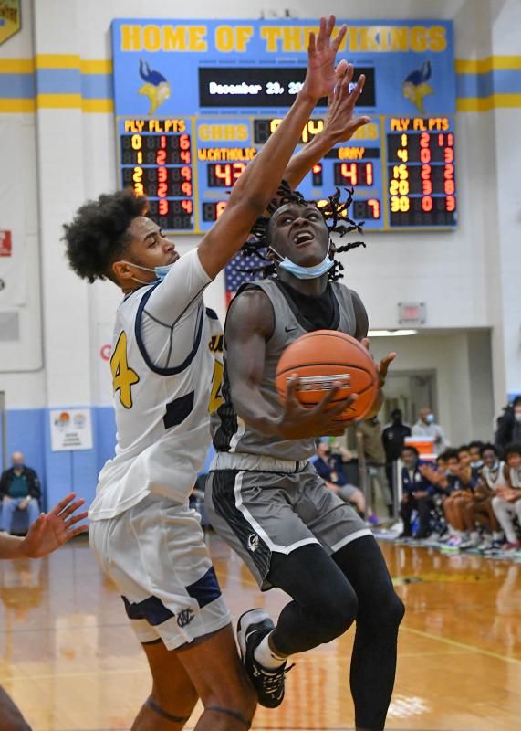 Gray’s Montraivis powers in the paint on West Catholic’s Nasir Griffin.