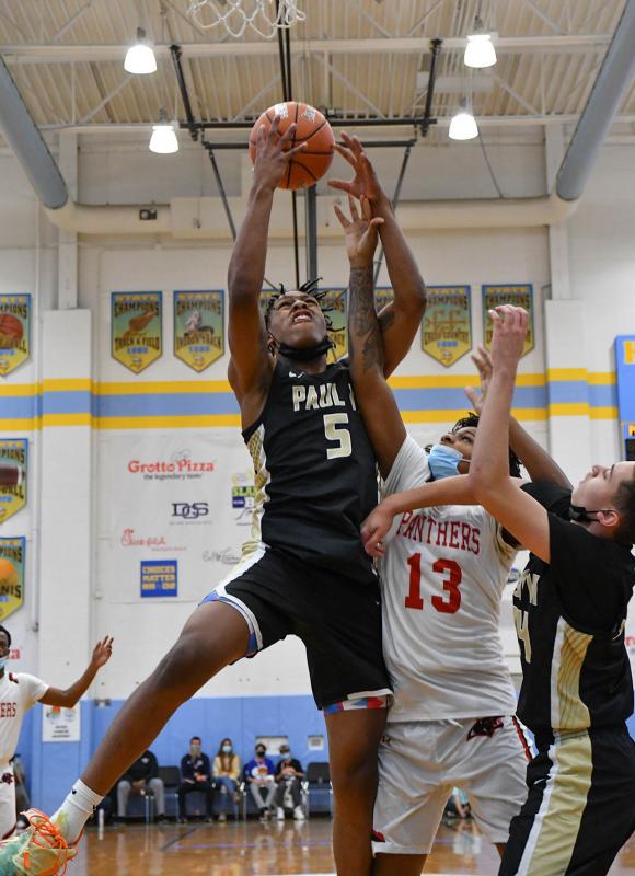 Paul VI Deshawn Harris-Smith grabs a rebound over Imhotep Charter’s Ma’Kye Taylor.