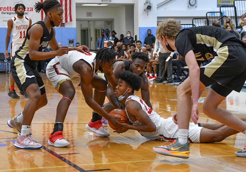 Paul VI and Imhotep players dive for a loose ball.
