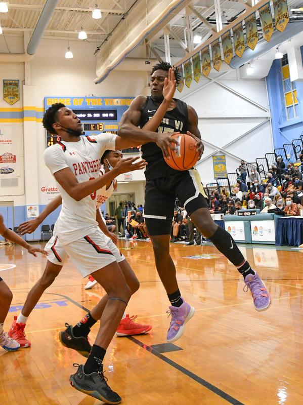 Paul VI forward Brenden Robinson snags a rebound from Imhotep’s Justin Edward.