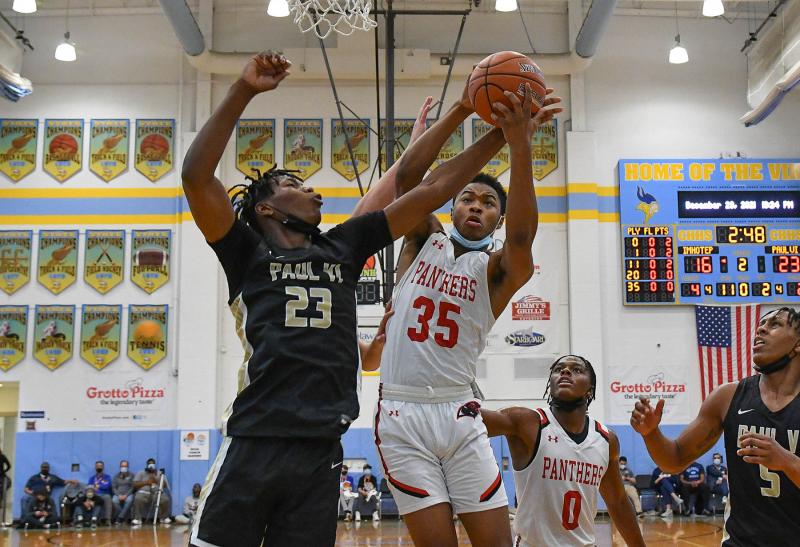 Imhotep’s Amaury Hunter, right, snags a rebound from Paul VI forward Jaquan Womack.