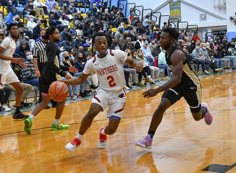 Imhotep’s Ronny Rapheal drives baseline to the paint.