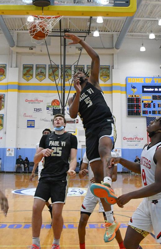 Paull VI guard Deshawn Harris-Smith jams a dunk.
