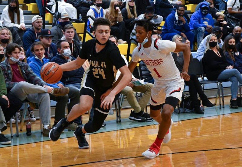 Paul VI Darrin Harris drives on Imhotep’s Rahmir Barno.
